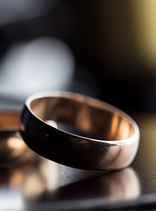 Wedding ring on top of a desk.