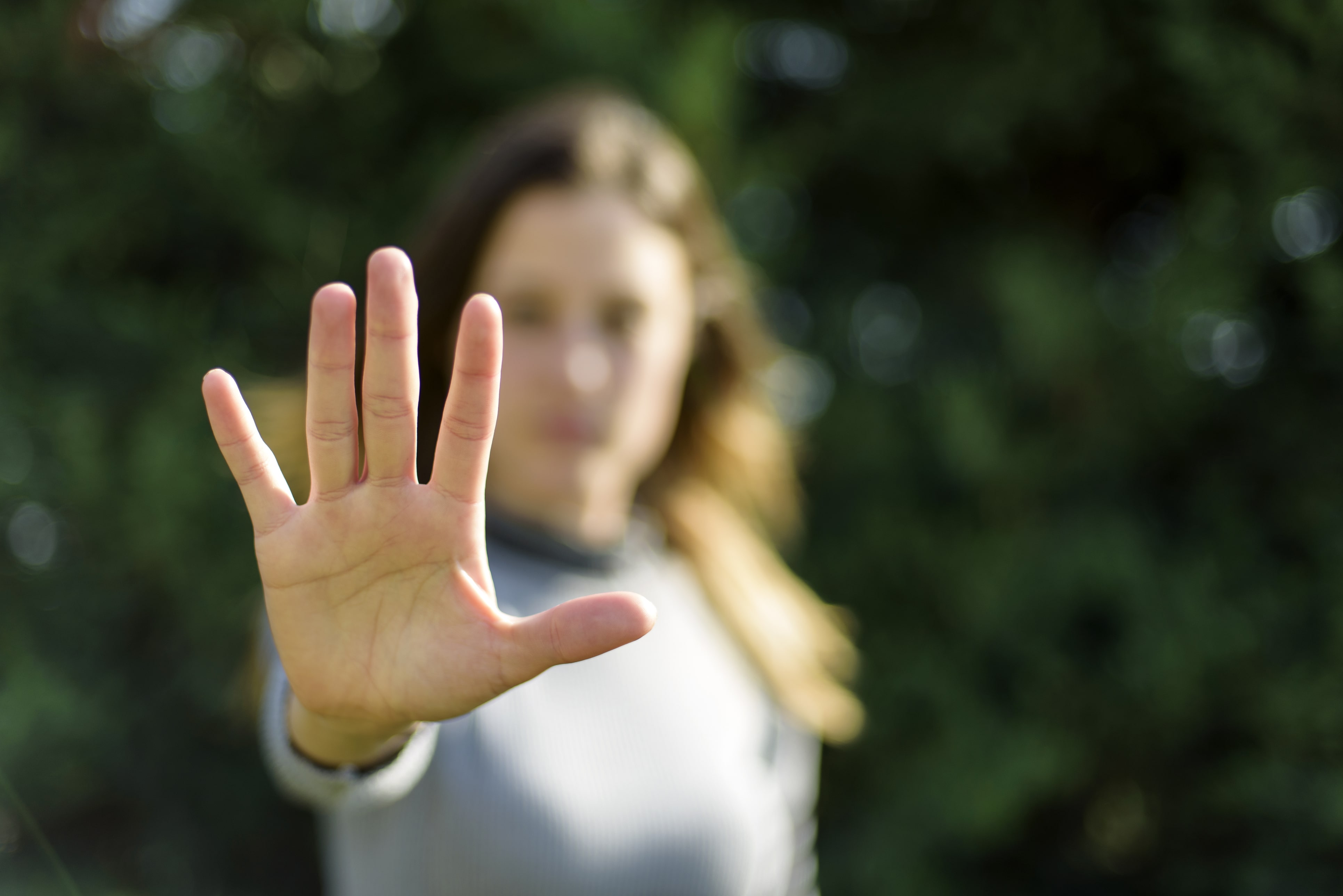 woman putting her hand up in defense